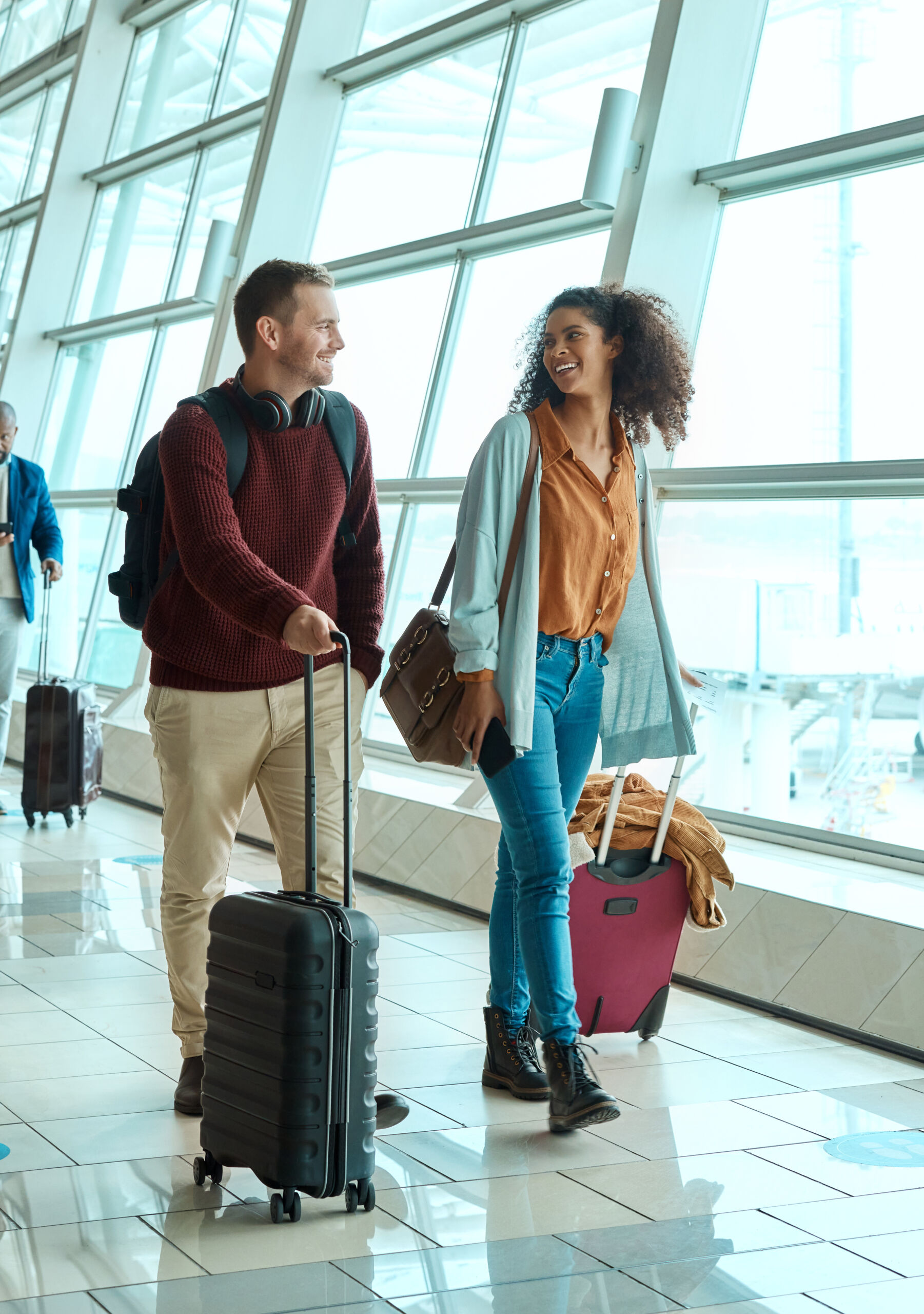 Travel, love and smile with interracial couple in airport for vacation, tourism and departure. Inte.